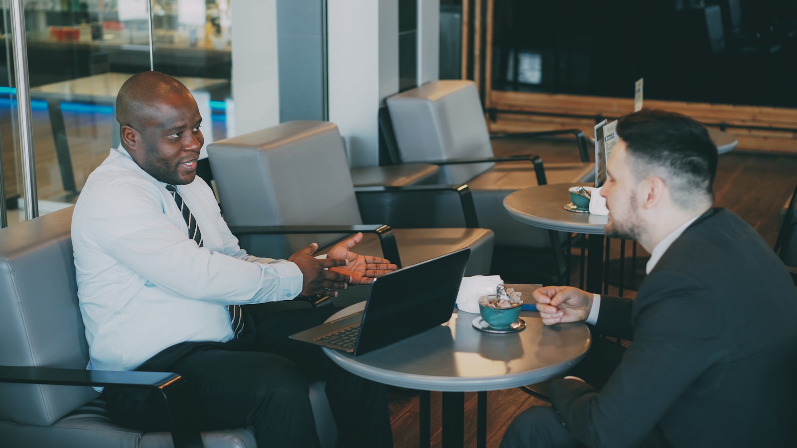 Two business partners talking through plans at a table